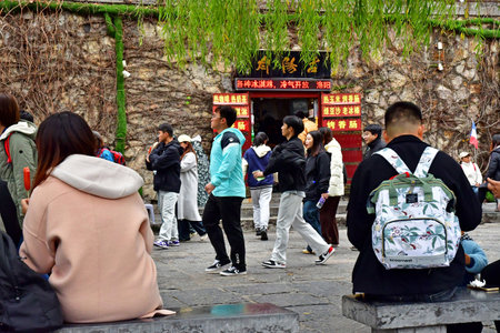 Luoyang; China - November 6 2024: Chinese tourist in the Longmen Grottoes siteのeditorial素材