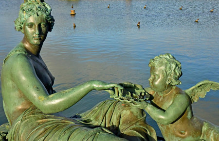 Versailles; France - November 26 2024: the castle of Louis 14, bronze statue on the water parterreのeditorial素材