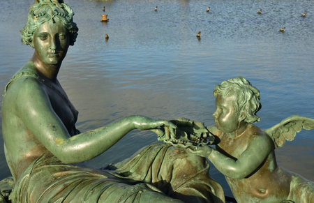 Versailles; France - November 26 2024: the castle of Louis 14, bronze statue on the water parterreのeditorial素材