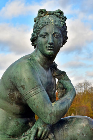 Versailles; France - November 26 2024: the castle of Louis 14, bronze statue on the water parterreのeditorial素材