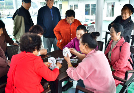 Maoping; China - November 6 2024: women are playing cards in cruise boat on the Yangtzeのeditorial素材