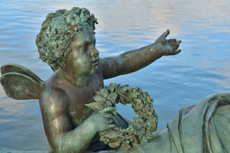 Versailles; France - November 26 2024: the castle of Louis 14, bronze statue on the water parterreのeditorial素材