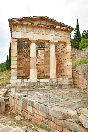 Delphi; Greece - August 31 2022: the Athenian Treasury in the archaeological site