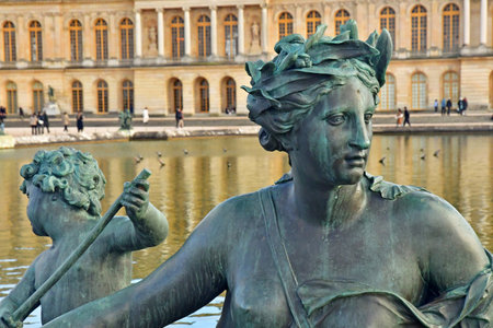 Versailles; France - November 26 2024: the castle of Louis 14, bronze statue on the water parterreのeditorial素材