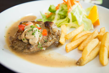 Delicious nourishing steak with vegetables, French fries の写真素材