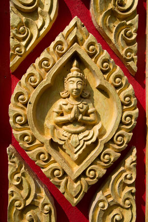 Sculpture on the wall of temple in Thailand の写真素材