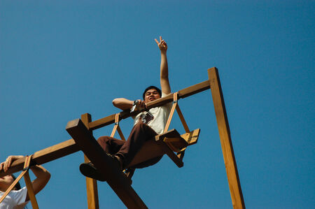 The young man playing the swing in the north of Thailand.のeditorial素材