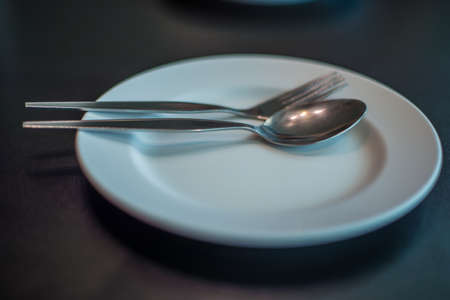 Empty dinner plate on the table in the restaurant, waitの写真素材