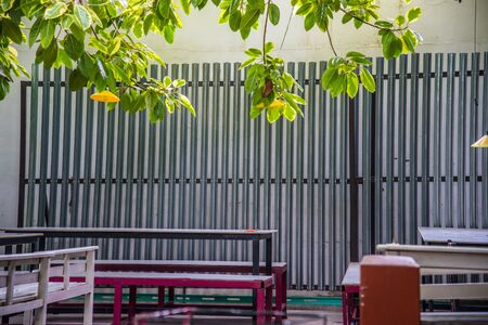 Wooden tables and chairs in the garden.の写真素材