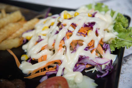 Pork steak with toast on a wooden table.の写真素材