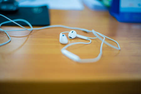 Earphone on a wooden table.Music,Listen
