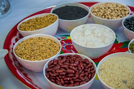 Many types of whole grains in the cup for Buddhist rituals.の写真素材