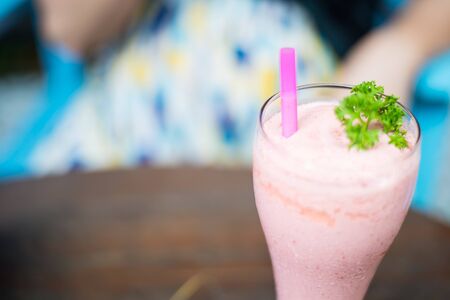Ice Strawberry Smoothie on the wooden table.