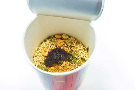 cooked instant cup noodle with ingredient on white backgroundの写真素材