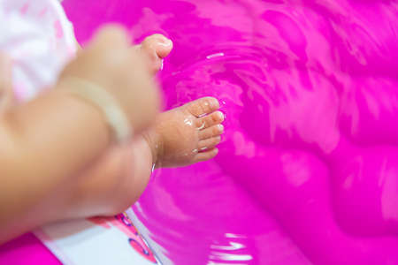 Baby foot touch the water.の写真素材