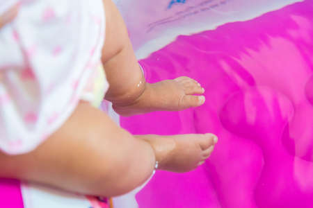 Baby foot touch the water.の写真素材