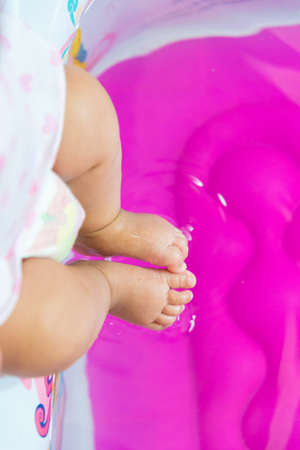 Baby foot touch the water.の写真素材