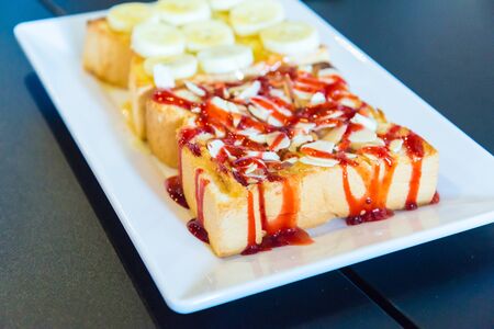 Buttered toast on the wooden table in the cafe.