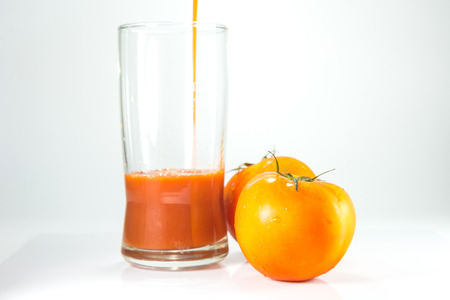 tomatoes juice on white background.の写真素材