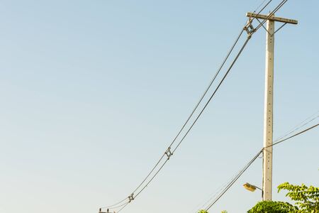 Electricity post and a blue sky background.の写真素材
