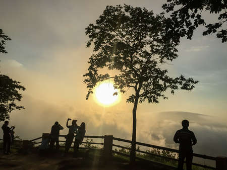 Sunrise in the morning, surrounded by mountains and mist.