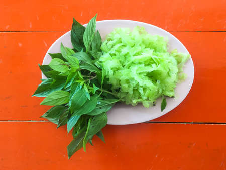 Fresh vegetables in the dish on orange table.の写真素材
