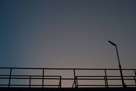 Silhouette of fence in the sunset for backbround.の写真素材