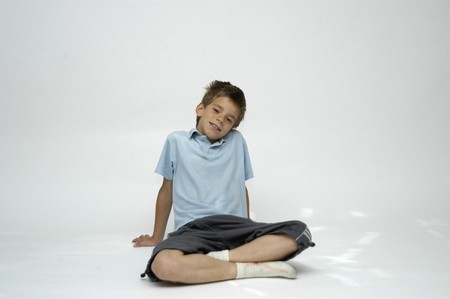 boy with short-sleeved shirt seatedの写真素材