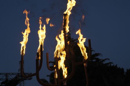 With fire torches lit at nightの写真素材