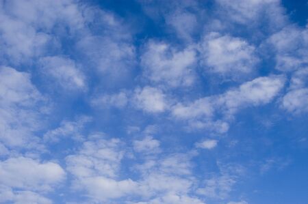 background of clouds against a blue skyの写真素材
