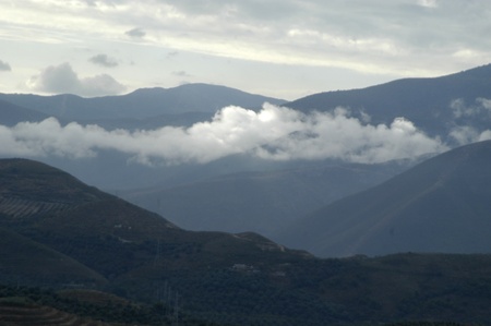 vista del valle de la alpujarra and sierra nevada in the background with low cloudsの写真素材