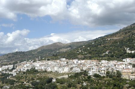 overview lanjarÃ³n with sierra nevada in the background with low clouds in the alpujarra in granadaの写真素材