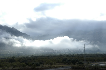 view lecrin valley to the sierra nevada in the background with low cloudsの写真素材