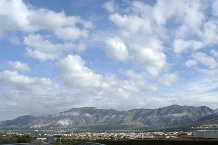view lecrin valley to the sierra nevada in the background with low cloudsの写真素材