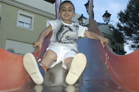 boy playing on a slideの写真素材
