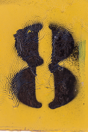 black number stencil painted on yellow backdrop, number 8, number eightの写真素材