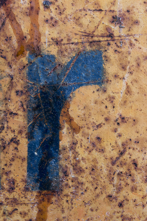 blue letter painted on rusty blue metal, blue stencil painted on rusty background, letter rの写真素材