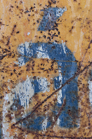 blue letter with tilde scratched rusty metal background, blue stencil painted on rusty background, letter a with tildeの写真素材