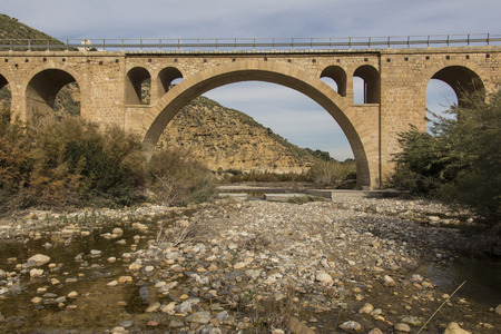 old stone bridge across the river, province of almeria, region of andalucia, spainの写真素材