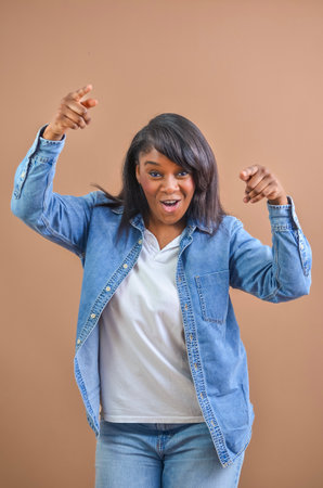 Young woman wearing casual clothes pointing her fingers and smiling in excitementの写真素材