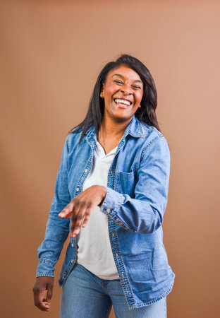 Studio portrait of a cheerful african american woman laughing and enjoying herselfの写真素材
