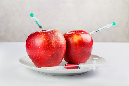 fresh juicy red apples on a plateの写真素材