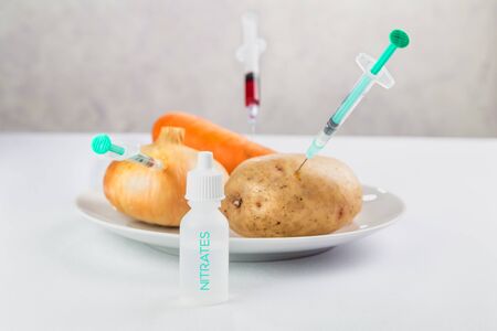 fresh juicy vegetables on a plate, treated with chemicals