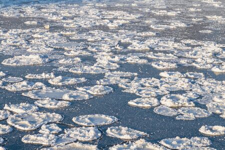 The freezing surface of the lake. Ice formation.