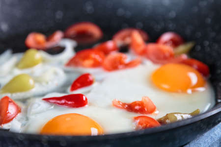 Cooking fried eggs. The ingredients are laid out in a griddle.の写真素材