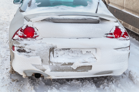 Parked cars covered with a thick layer of snow. Consequences of a heavy snowfall.の写真素材