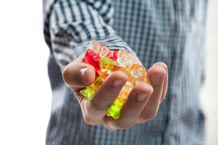 candy bears gelatine placer in the child's handの写真素材