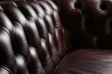 texture of the dark leather couch stitched buttons