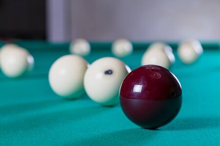 balls for Russian Billiards on billiard table with a green cloth scored in the pocket billiard ballsの写真素材
