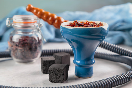 shisha with Apple flavor in glossy blue bowl, cooked for Smoking